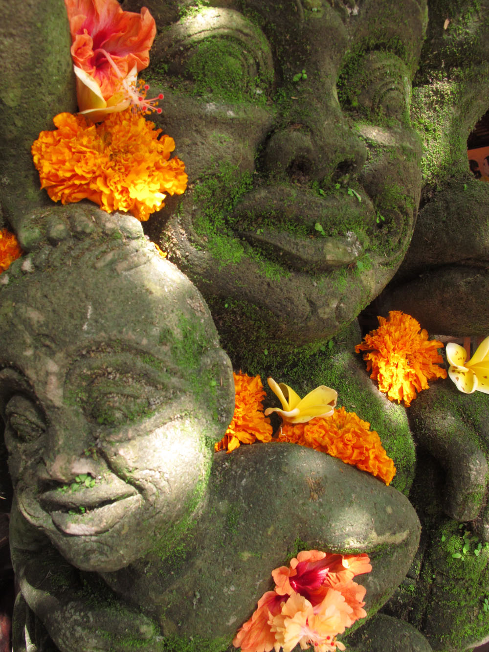 Marigolds adorn a Balinese sculpture