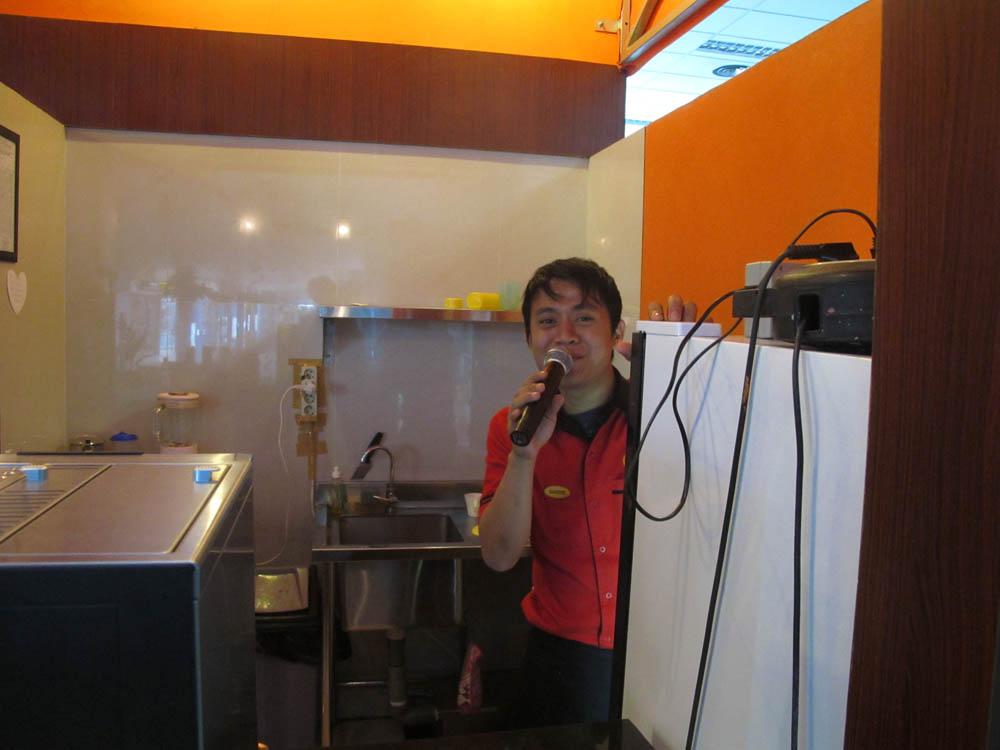 guy at a food stall in the Jakarta airport was singing Kareoke behind the counter