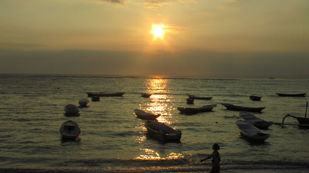 Sunset over Bali with moored fishing boats