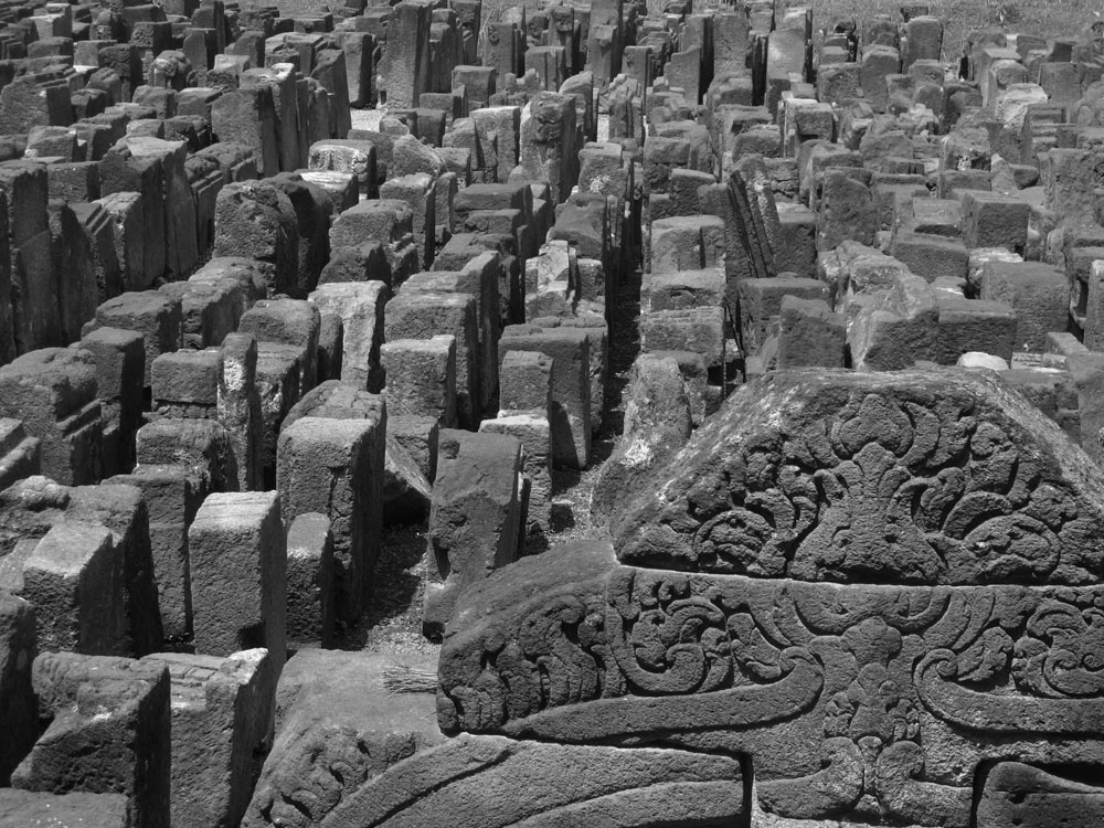 unplaced stones sit outside Borobudur Temple on Java