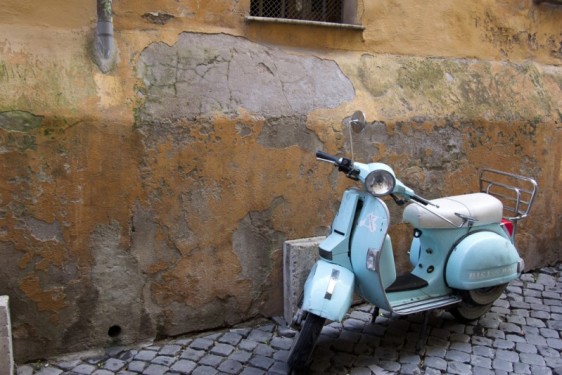 Turquoise Vespa against aging Roman walls in Trastevere | Rome, Italy