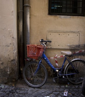 Bicycle against street pipe | Rome, Italy